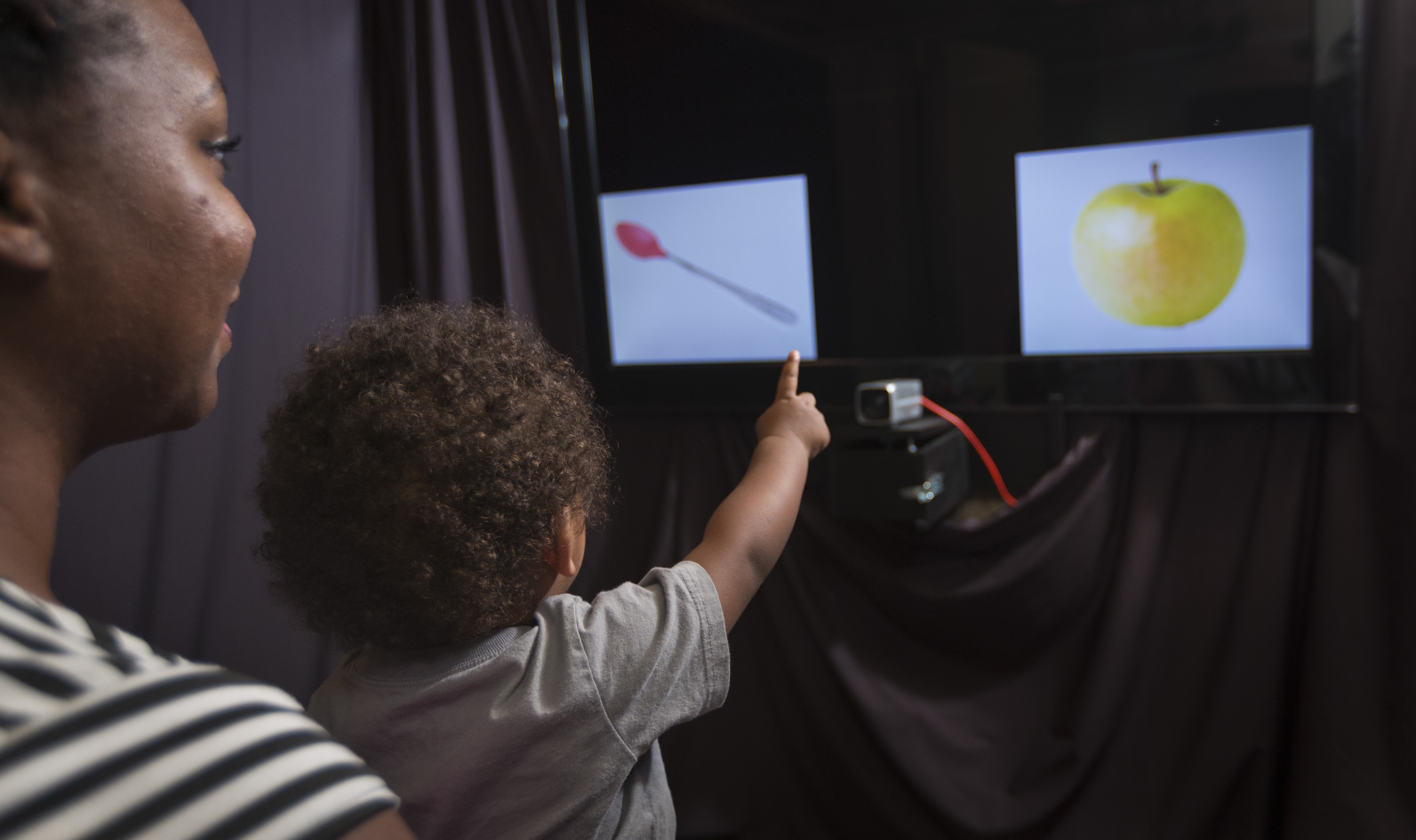 Child pointing at screen